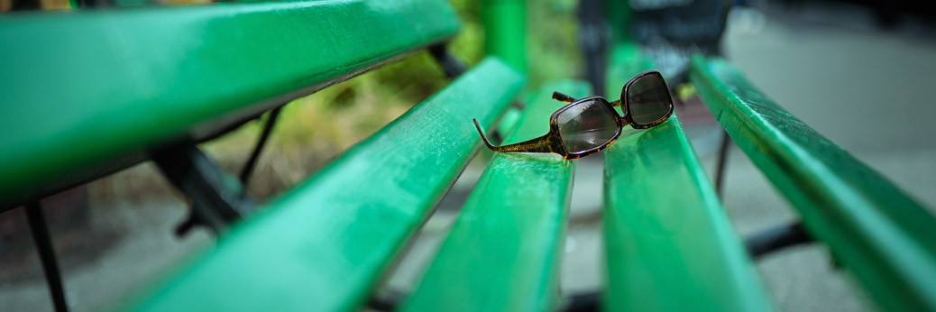 Sunglasses On Green Bench